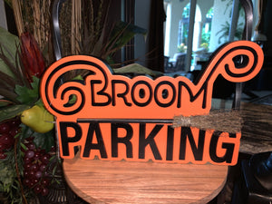 BROOM PARKING sign